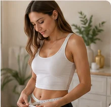 Client measuring her waist during a wellness program